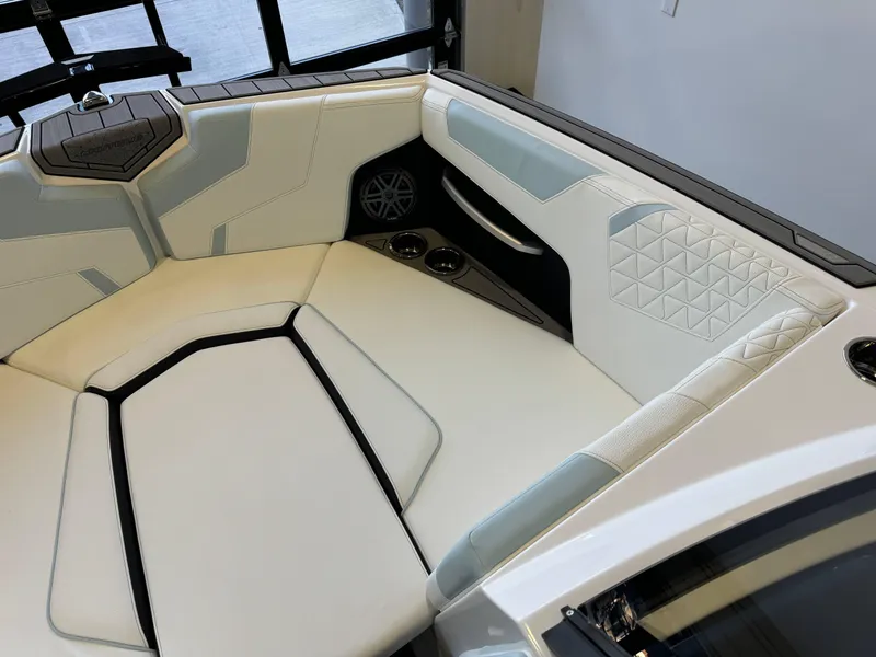 Slide: The Image of 2025 Nautique Super Air Nautique GS22 interior with white and gray seating, modern design. - 18