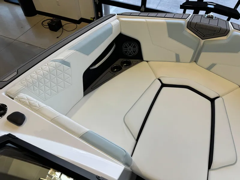 Slide: The Image of 2025 Nautique Super Air Nautique GS22 interior with white and gray seating. - 19