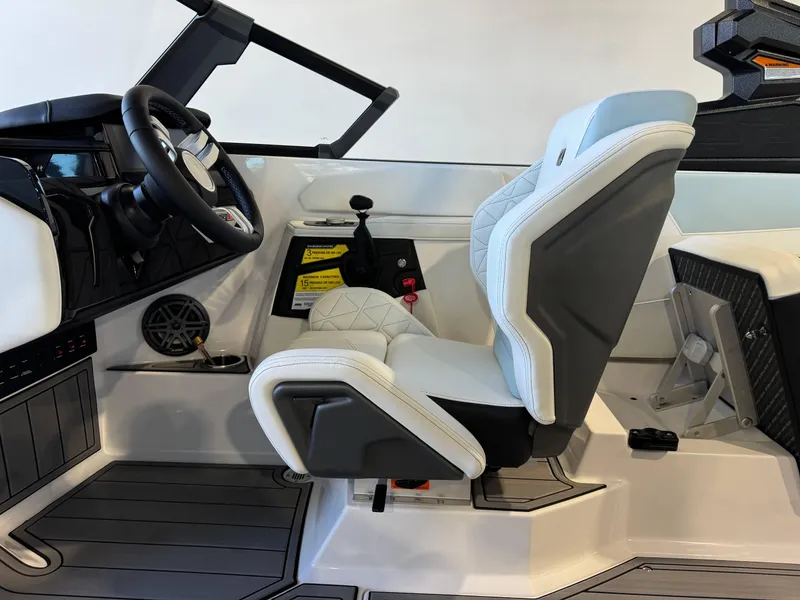 Slide: The Image of 2025 Nautique Super Air Nautique GS22 cockpit with modern steering and seating. - 23