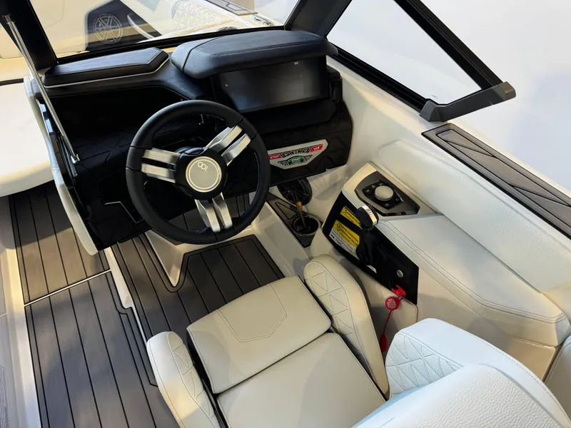 Slide: The Image of 2025 Nautique Super Air Nautique GS22 interior with sleek steering wheel and modern dashboard. - 26