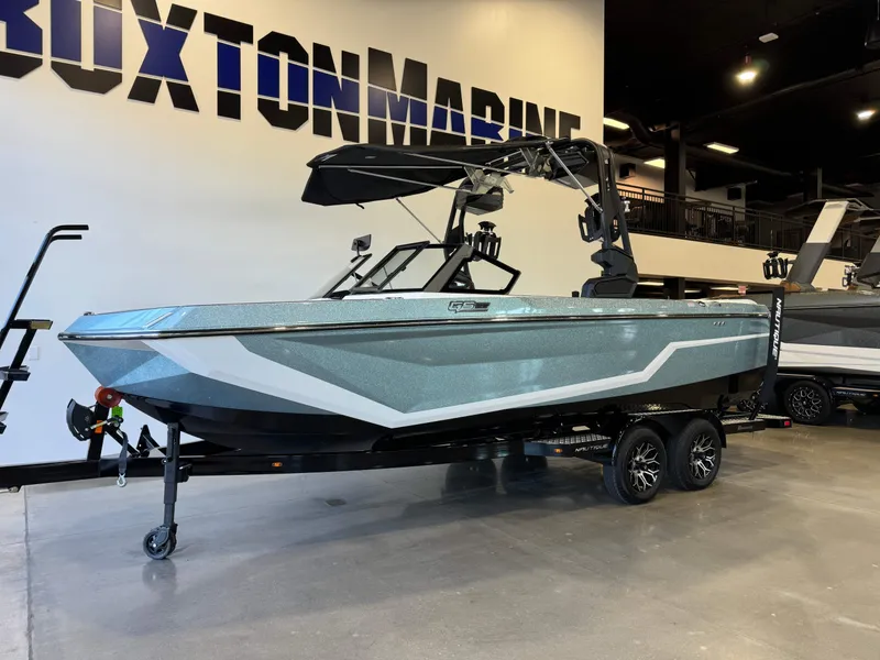 Slide: The Image of 2025 Nautique Super Air Nautique GS22 boat displayed indoors on a trailer. - 3