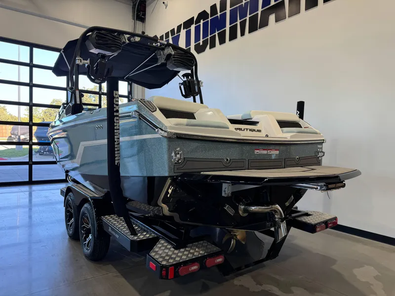 Slide: The Image of 2025 Nautique Super Air Nautique GS22 boat in showroom, rear view. - 5