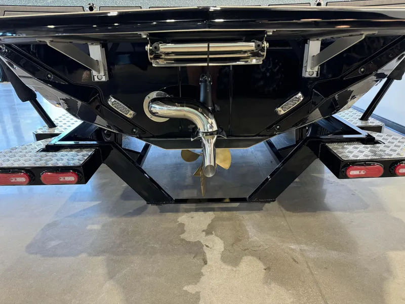Slide: The Image of 2025 Nautique Super Air Nautique GS22 boat trailer with propeller and exhaust detail. - 7