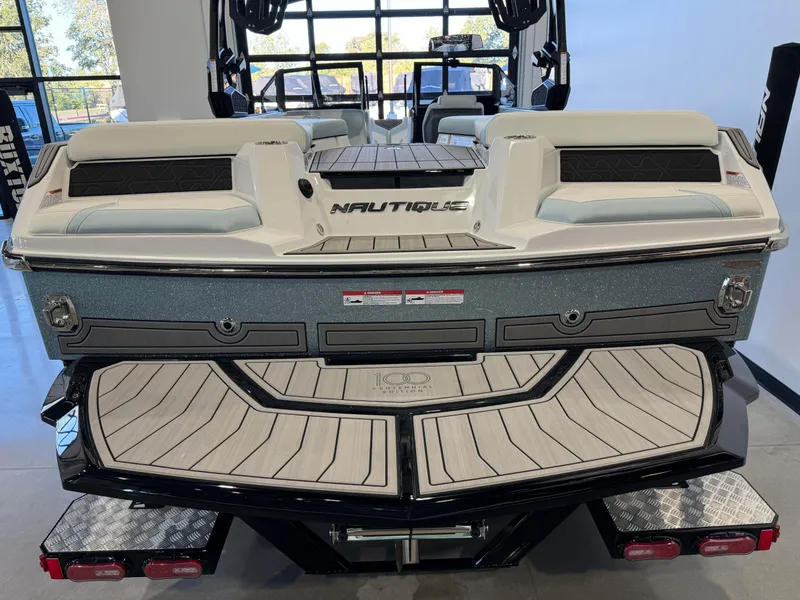 Slide: The Image of 2025 Nautique Super Air Nautique GS22 boat rear view in showroom. - 8
