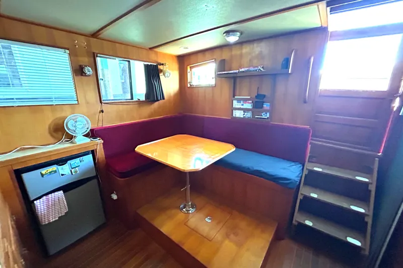 Slide: The Image of Cozy interior of 1985 Sundowner Tug Princess Louisa with dining area and compact kitchen. - 12