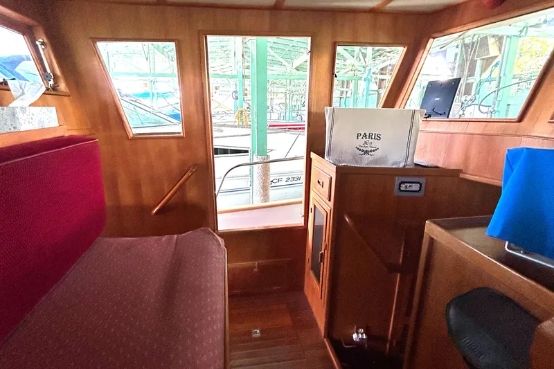 Slide: The Image of Interior of 1985 Sundowner Tug Princess Louisa with wooden finish and red seating. - 22