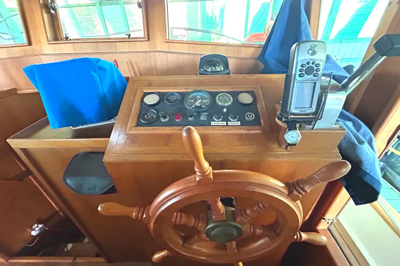 Slide: The Image of Wooden helm of 1985 Sundowner Tug Princess Louisa with navigation instruments and controls. - 23