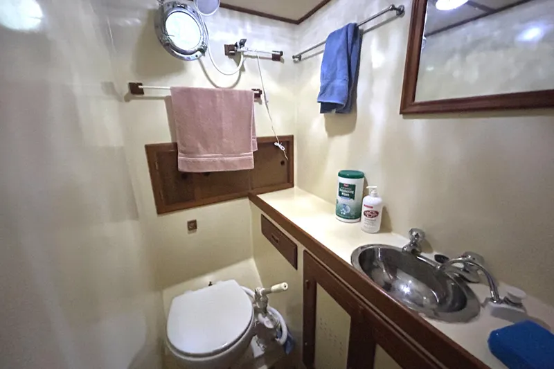 Slide: The Image of 1985 Sundowner Tug Princess Louisa bathroom with sink, toilet, and towels. - 30