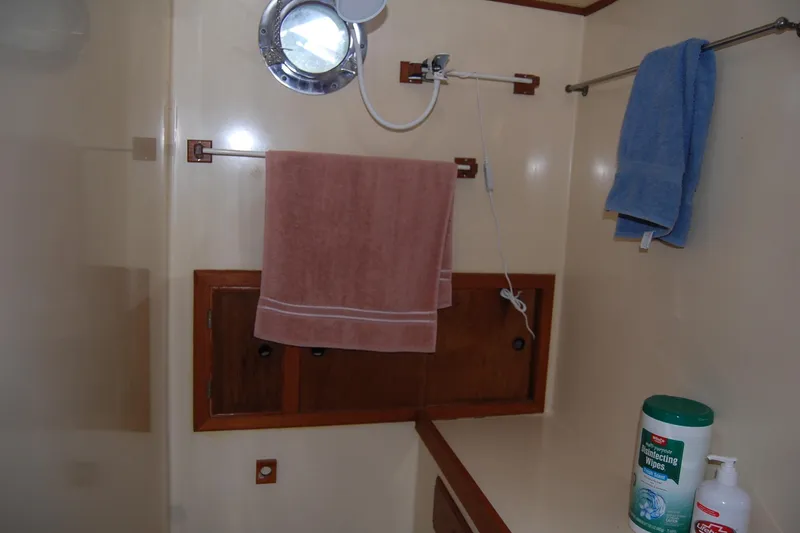 Slide: The Image of Bathroom interior of 1985 Sundowner Tug Princess Louisa with towels and cleaning supplies. - 32