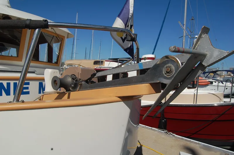 Slide: The Image of 1985 Sundowner Tug Princess Louisa boat with anchor mechanism, docked in a marina. - 33