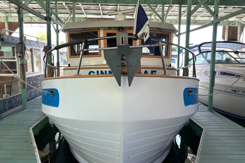 Slide: The Image of 1985 Sundowner Tug Princess Louisa docked in a covered marina. - 34