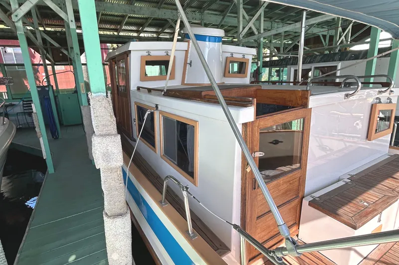 Slide: The Image of 1985 Sundowner Tug Princess Louisa docked in a covered marina. - 35
