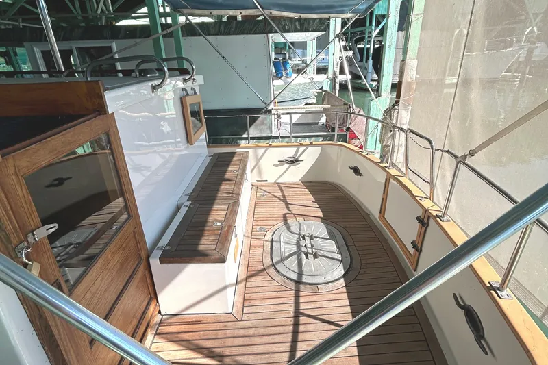 Slide: The Image of 1985 Sundowner Tug Princess Louisa deck with wooden flooring and seating area. - 36