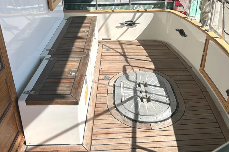 Slide: The Image of 1985 Sundowner Tug Princess Louisa deck with wooden flooring and storage compartments. - 37