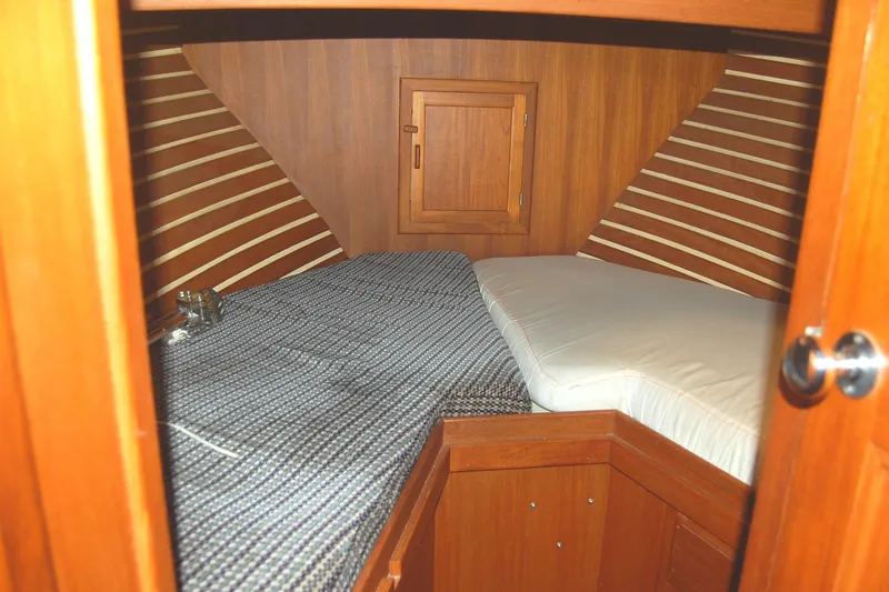 Slide: The Image of Cozy cabin interior of 1985 Sundowner Tug Princess Louisa with wooden finish and bedding. - 5