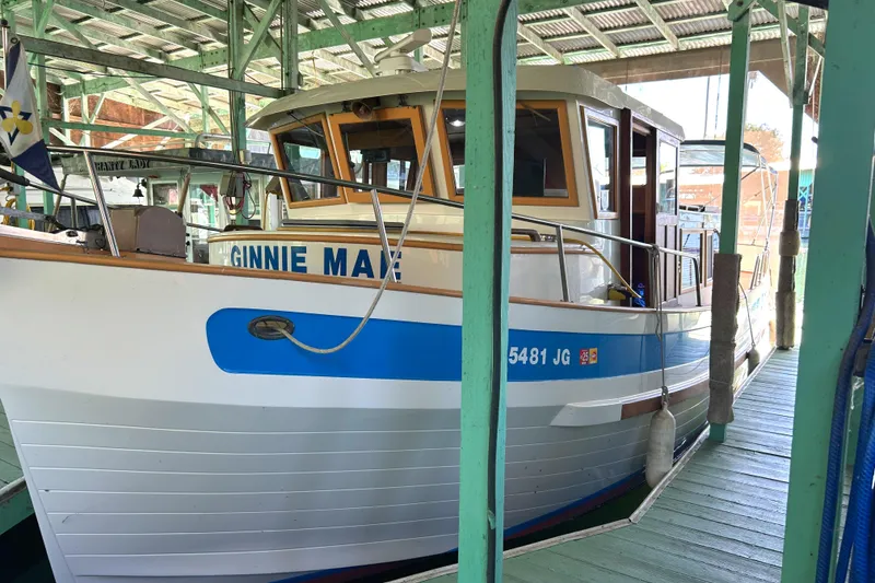 Slide: The Image of 1985 Sundowner Tug Princess Louisa docked, featuring a white and blue exterior. - 7