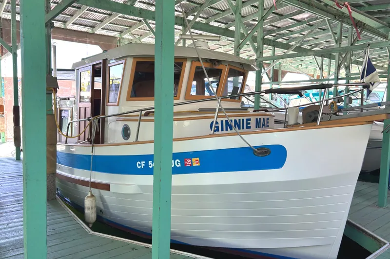 Slide: The Image of 1985 Sundowner Tug Princess Louisa docked in a covered marina. - 8