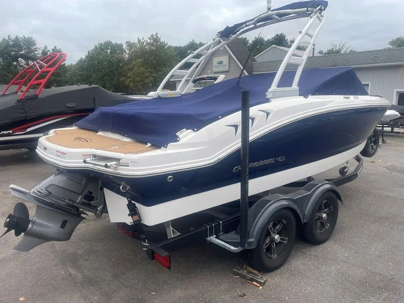 Slide: The Image of 2023 Chaparral 21 SSi boat on trailer, covered, with sleek design and dual axle wheels. - 14