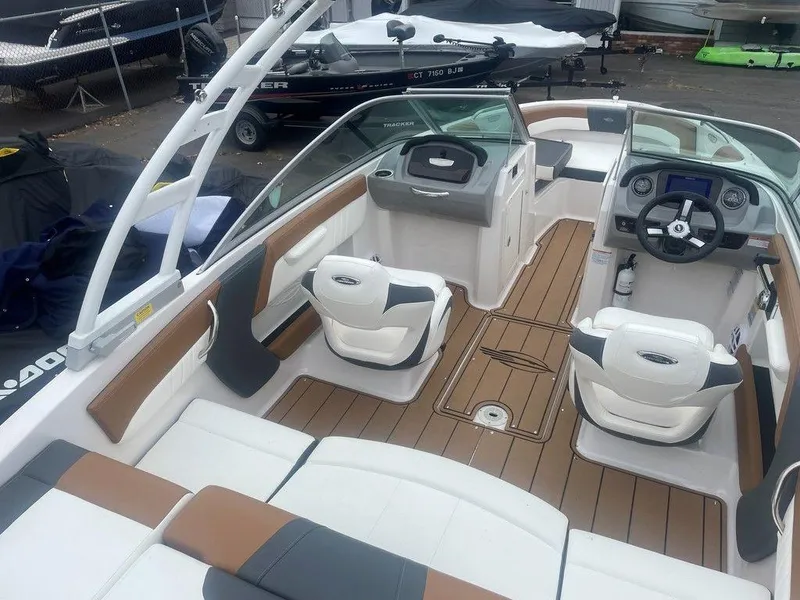 Slide: The Image of 2023 Chaparral 21 SSi boat interior with modern seating and dashboard design. - 16