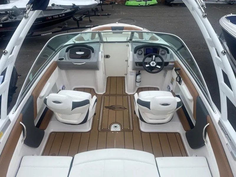 Slide: The Image of 2023 Chaparral 21 SSi boat interior with dual seats and modern dashboard. - 17