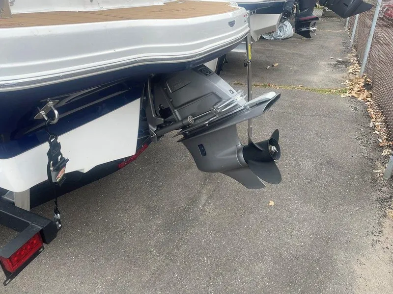 Slide: The Image of 2023 Chaparral 21 SSi boat stern with outboard motor on pavement. - 20