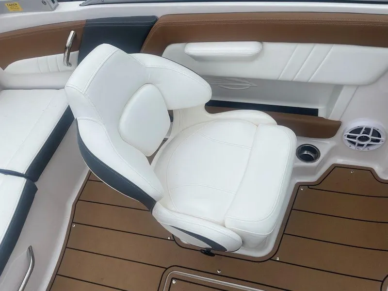 Slide: The Image of 2023 Chaparral 21 SSi boat interior with white seat and brown flooring. - 21