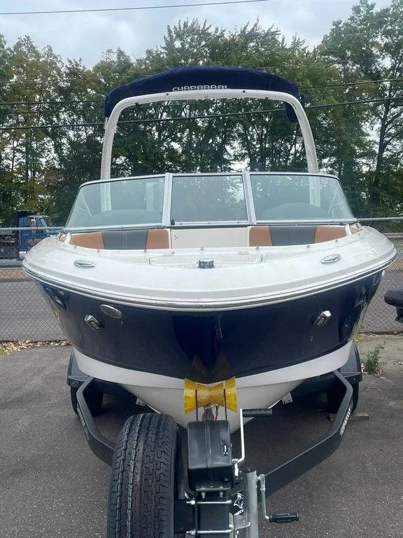 Slide: The Image of 2023 Chaparral 21 SSi boat on trailer, front view, outdoors. - 22