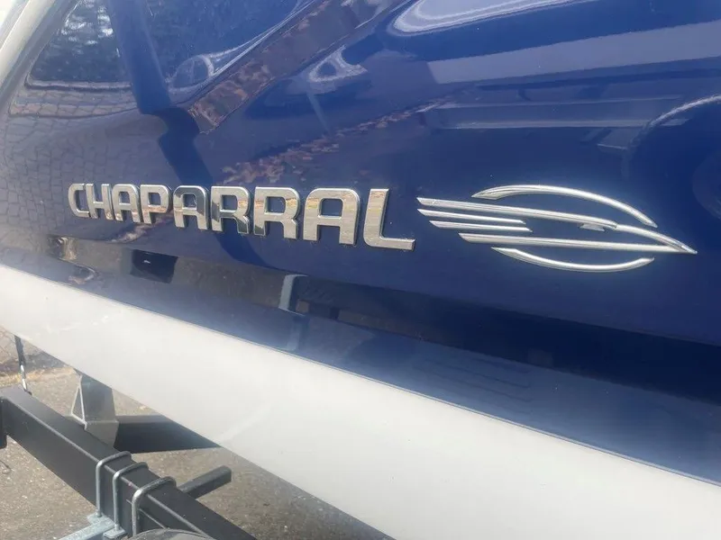 Slide: The Image of 2023 Chaparral 21 SSi boat logo on blue and white hull. - 23