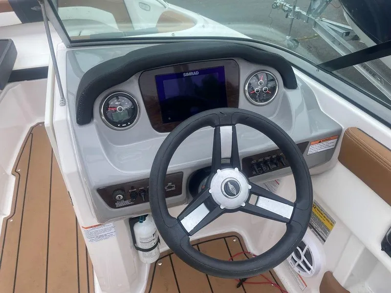 Slide: The Image of 2023 Chaparral 21 SSi boat dashboard with steering wheel and control panel. - 5