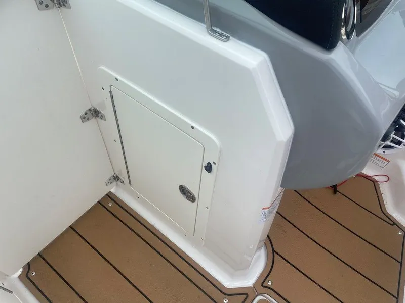 Slide: The Image of 2023 Chaparral 21 SSi boat interior with white panel and brown flooring. - 6