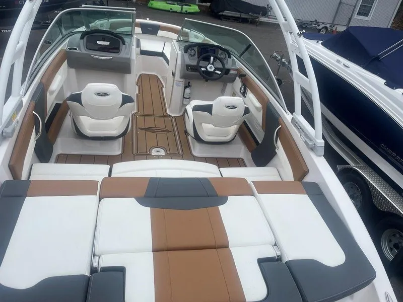Slide: The Image of 2023 Chaparral 21 SSi boat interior with stylish seating and modern dashboard. - 8