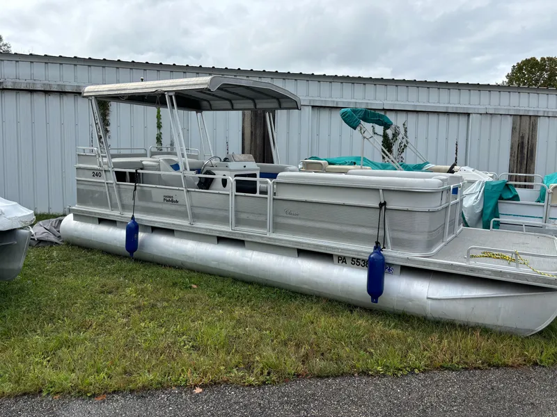 The Image of 1992 Harris FloteBote 240 Classic pontoon boat parked on grass near a metal building. - 0