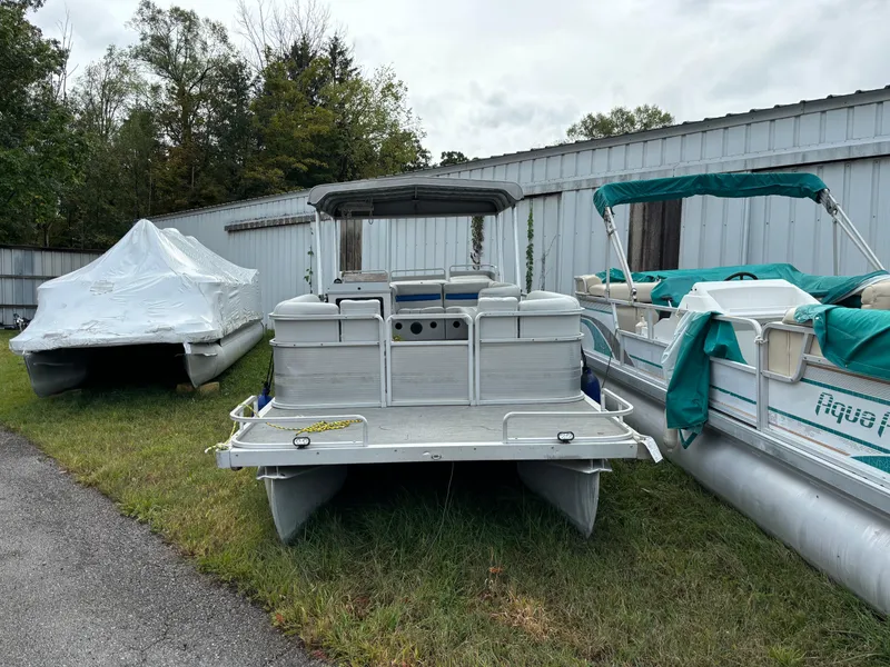 Slide: The Image of 1992 Harris FloteBote 240 Classic pontoon boat parked outdoors near other boats. - 3