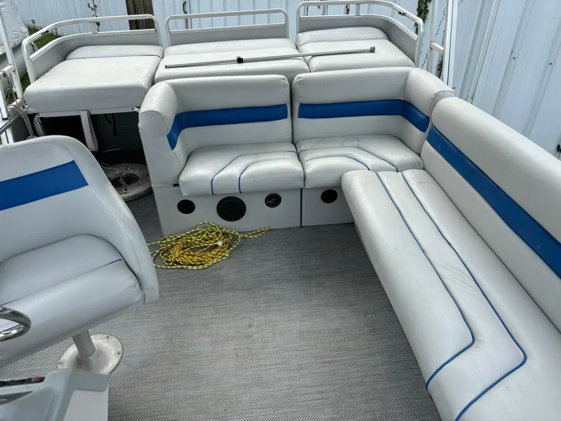Slide: The Image of Interior of a 1992 Harris FloteBote 240 Classic pontoon boat with white and blue seating. - 8