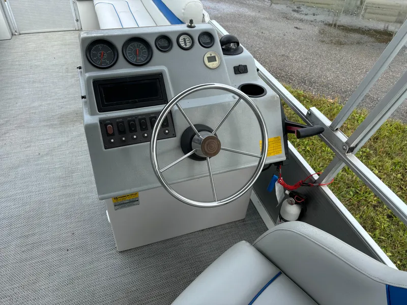 Slide: The Image of 1992 Harris FloteBote 240 Classic boat dashboard with steering wheel and gauges. - 9