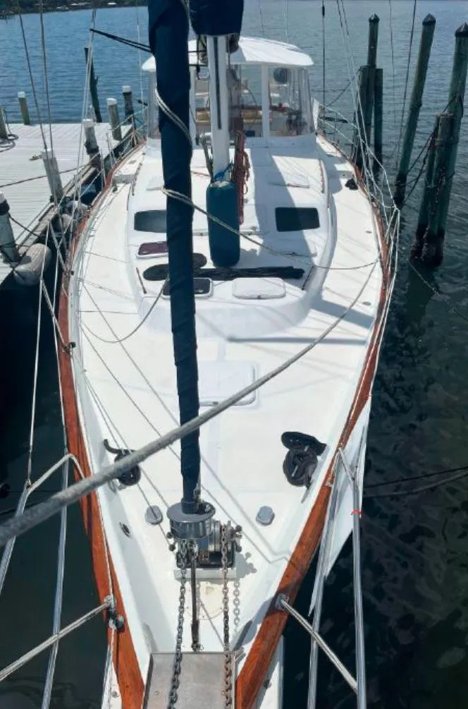 Slide: The Image of Irwin 54 sailboat, 1990 model, docked at marina with wooden trim and white deck. - 11