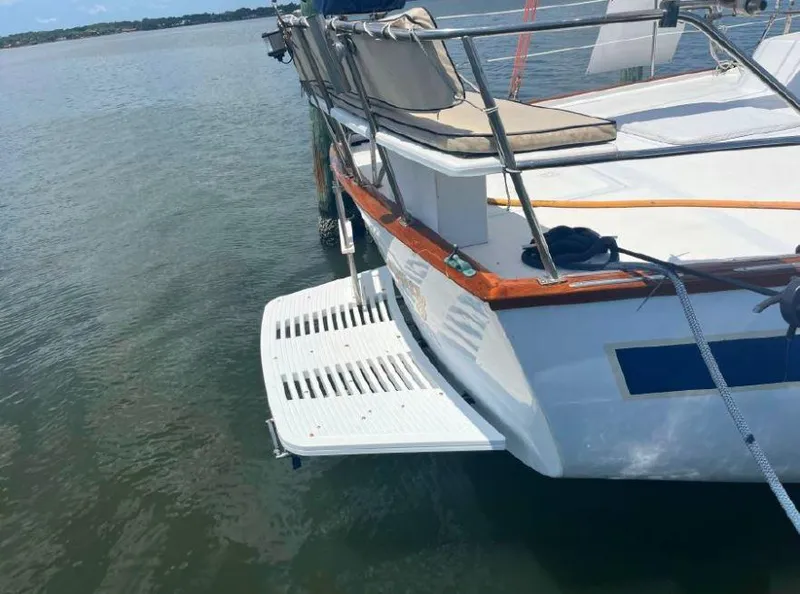 Slide: The Image of Irwin 54 sailboat from 1990 with swim platform, docked on calm water. - 14