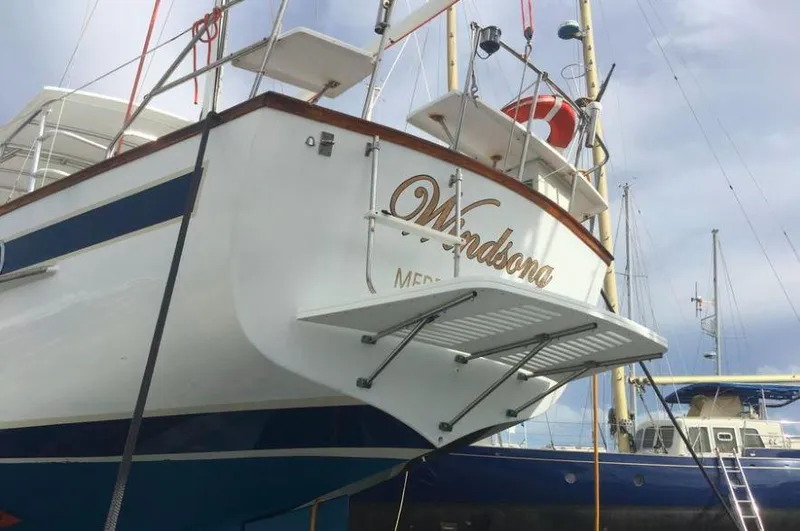 Slide: The Image of Irwin 54 sailboat from 1990 docked, featuring elegant design and spacious deck. - 15