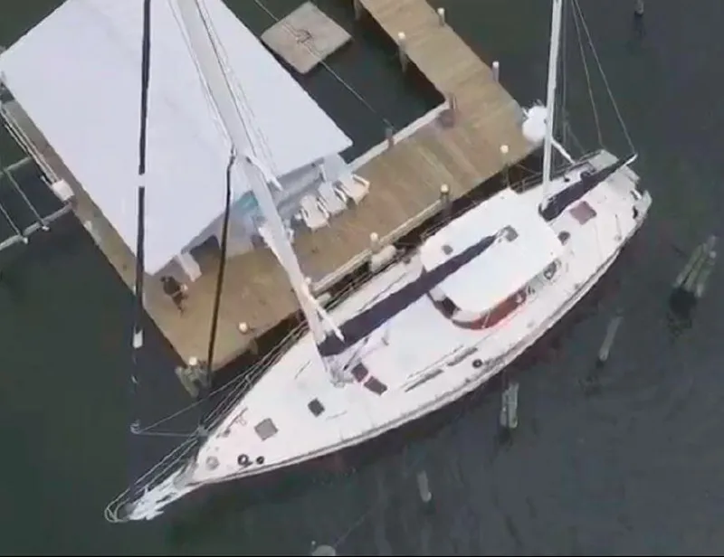 Slide: The Image of Aerial view of 1990 Irwin 54 yacht docked at a wooden pier. - 17