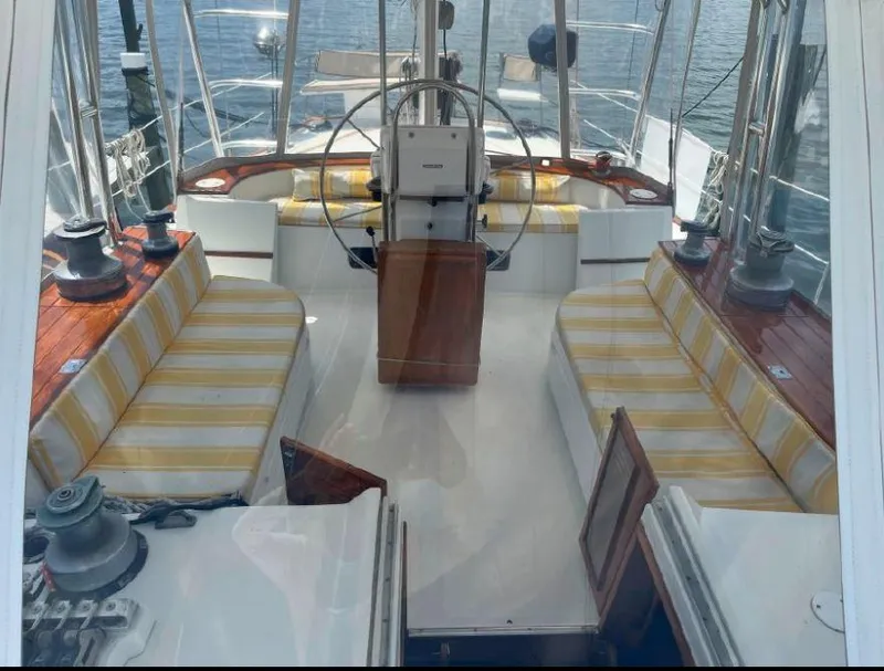 Slide: The Image of Interior of 1990 Irwin 54 sailboat with striped seating and steering wheel. - 23