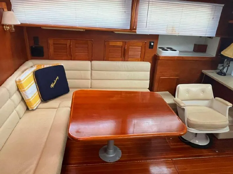 Slide: The Image of Interior of 1990 Irwin 54 yacht with wooden table and beige seating. - 28