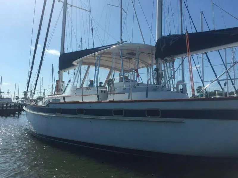 Slide: The Image of Irwin 54 sailboat, 1990 model, docked in marina under clear sky. - 3
