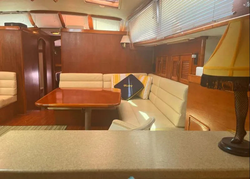 Slide: The Image of Interior of 1990 Irwin 54 yacht with wooden finishes and cozy seating area. - 30