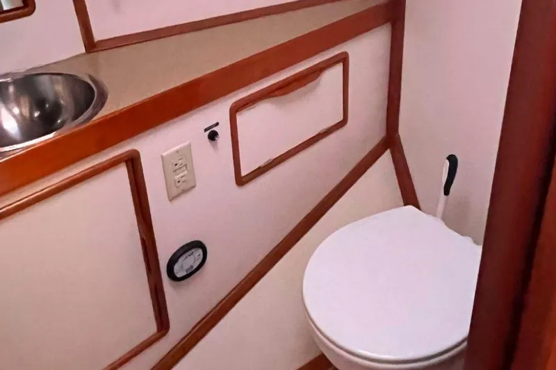 Slide: The Image of Compact bathroom in a 1990 Irwin 54 yacht with sink and toilet. - 35