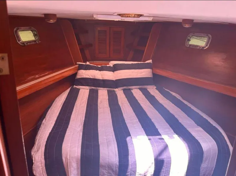 Slide: The Image of Cozy cabin interior of 1990 Irwin 54 sailboat with striped bedding. - 36