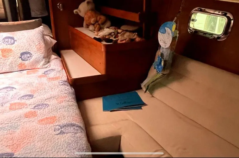 Slide: The Image of Cozy cabin interior of 1990 Irwin 54 sailboat with bed and stuffed animals. - 38