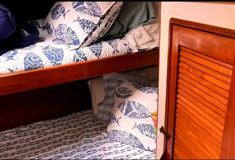 Slide: The Image of Cozy cabin bunks with nautical bedding on a 1990 Irwin 54 sailboat. - 40