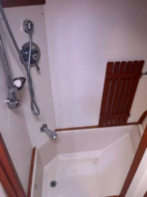 Slide: The Image of 1990 Irwin 54 yacht shower with wooden accents and chrome fixtures. - 42
