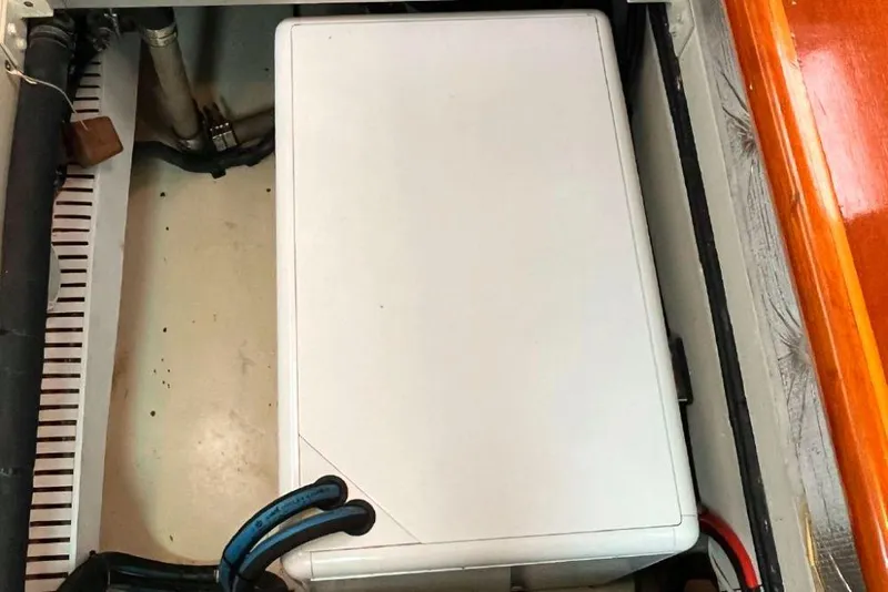 Slide: The Image of Engine compartment of a 1990 Irwin 54 sailboat with visible wiring and components. - 43