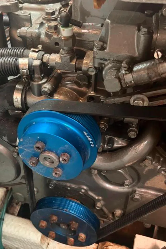 Slide: The Image of Close-up of a 1990 Irwin 54 engine with blue pulleys. - 45